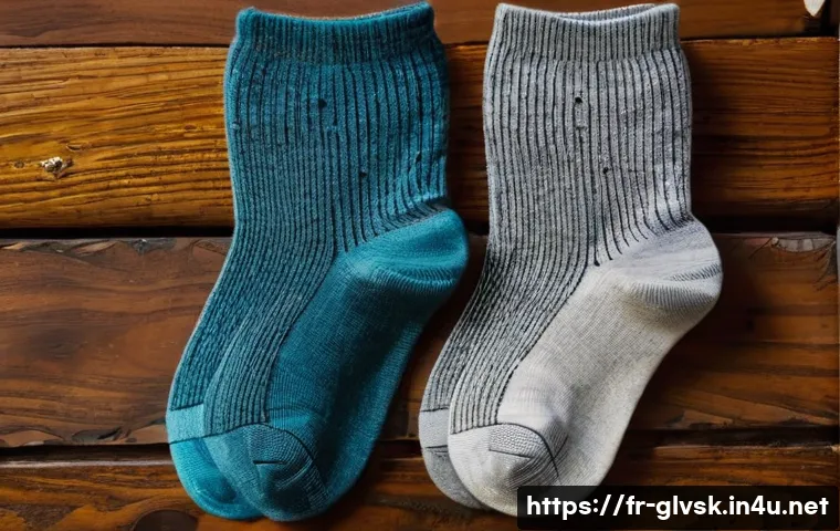 양말 세탁 방법 및 관리 팁 - A detailed close-up image of three pairs of socks arranged neatly on a wooden surface, each pair mad...